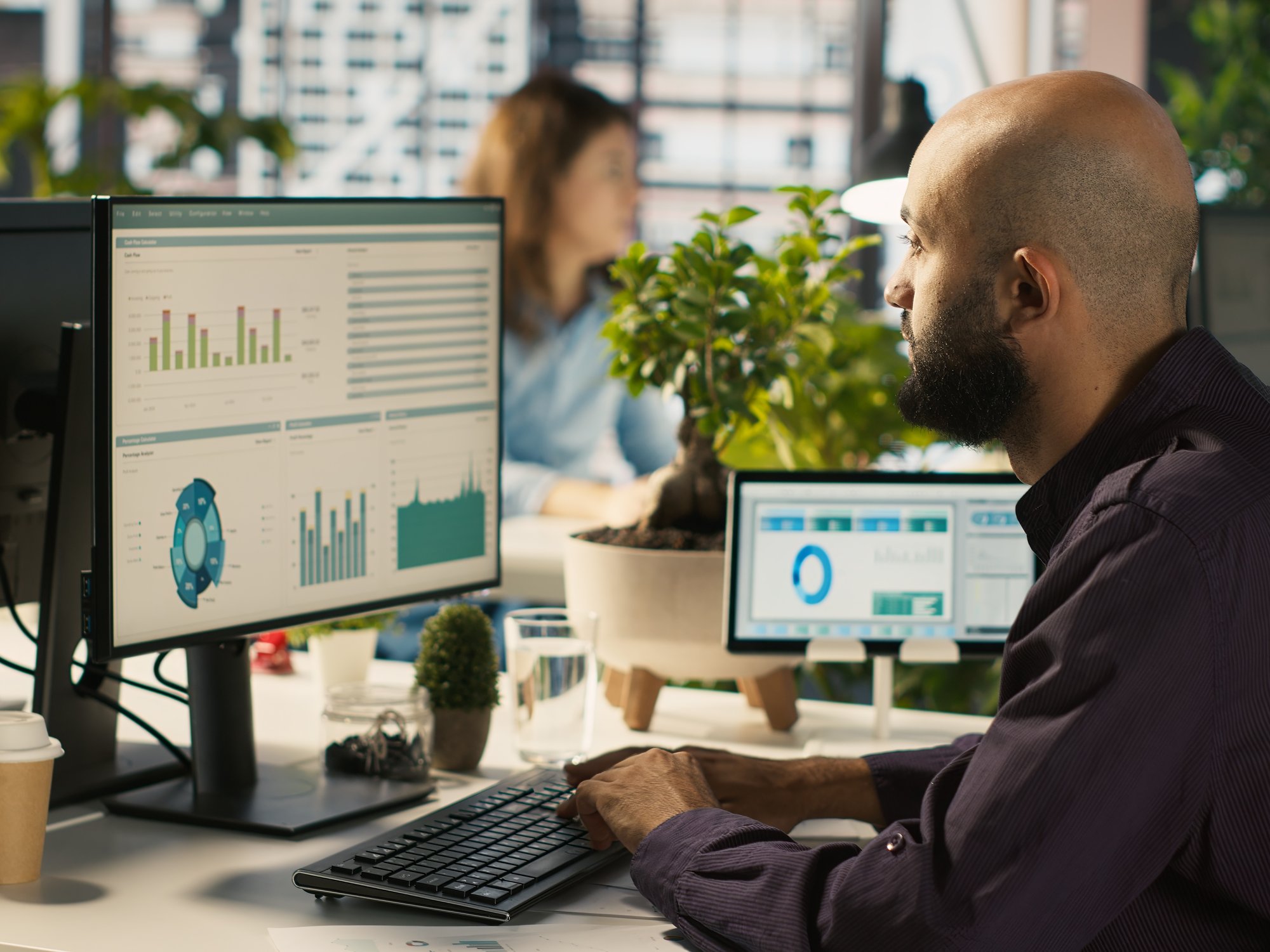 employee-editing-documents-desktop-computer-office-desk